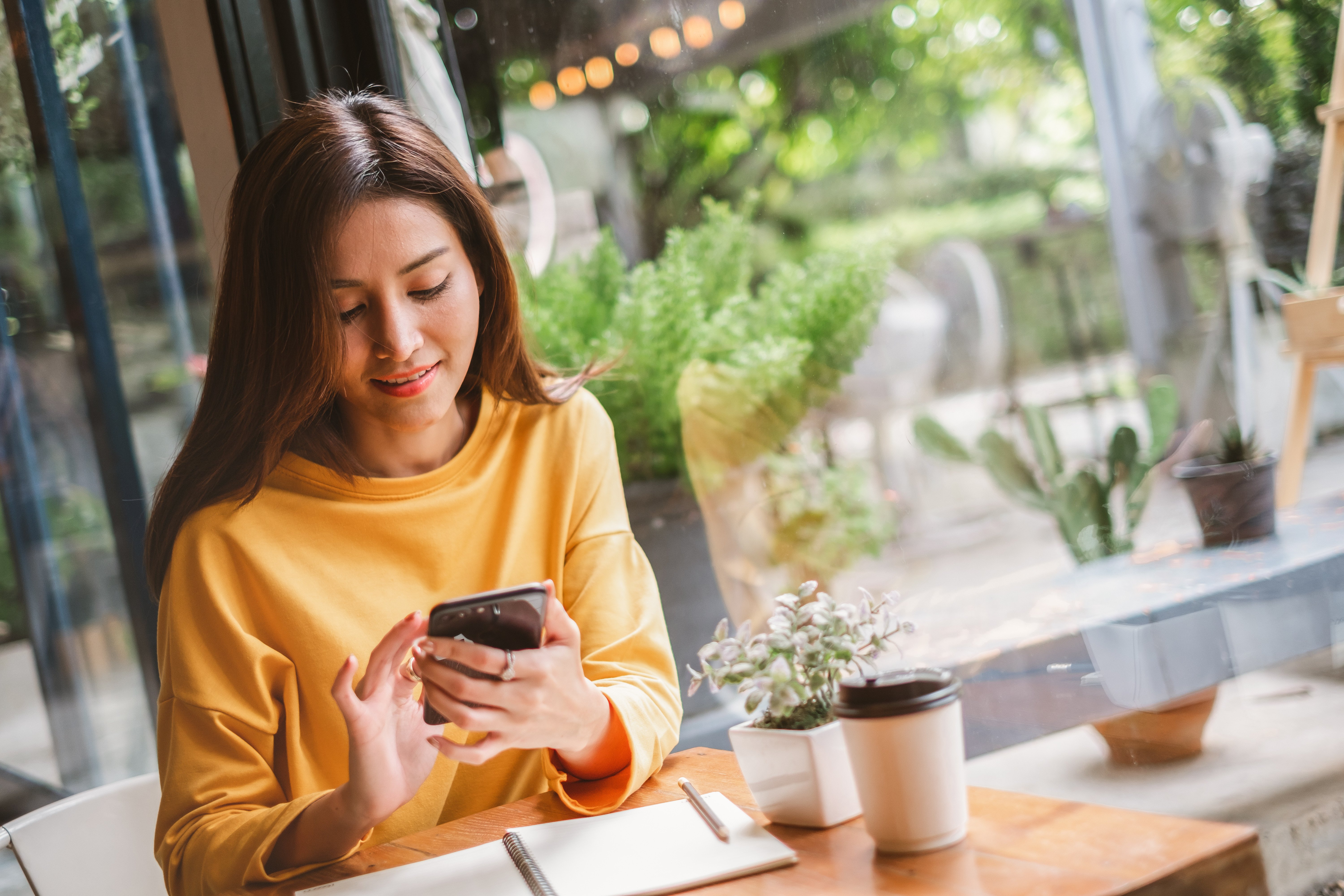 A woman checks the status of her direct deposit on her credit union mobile app.