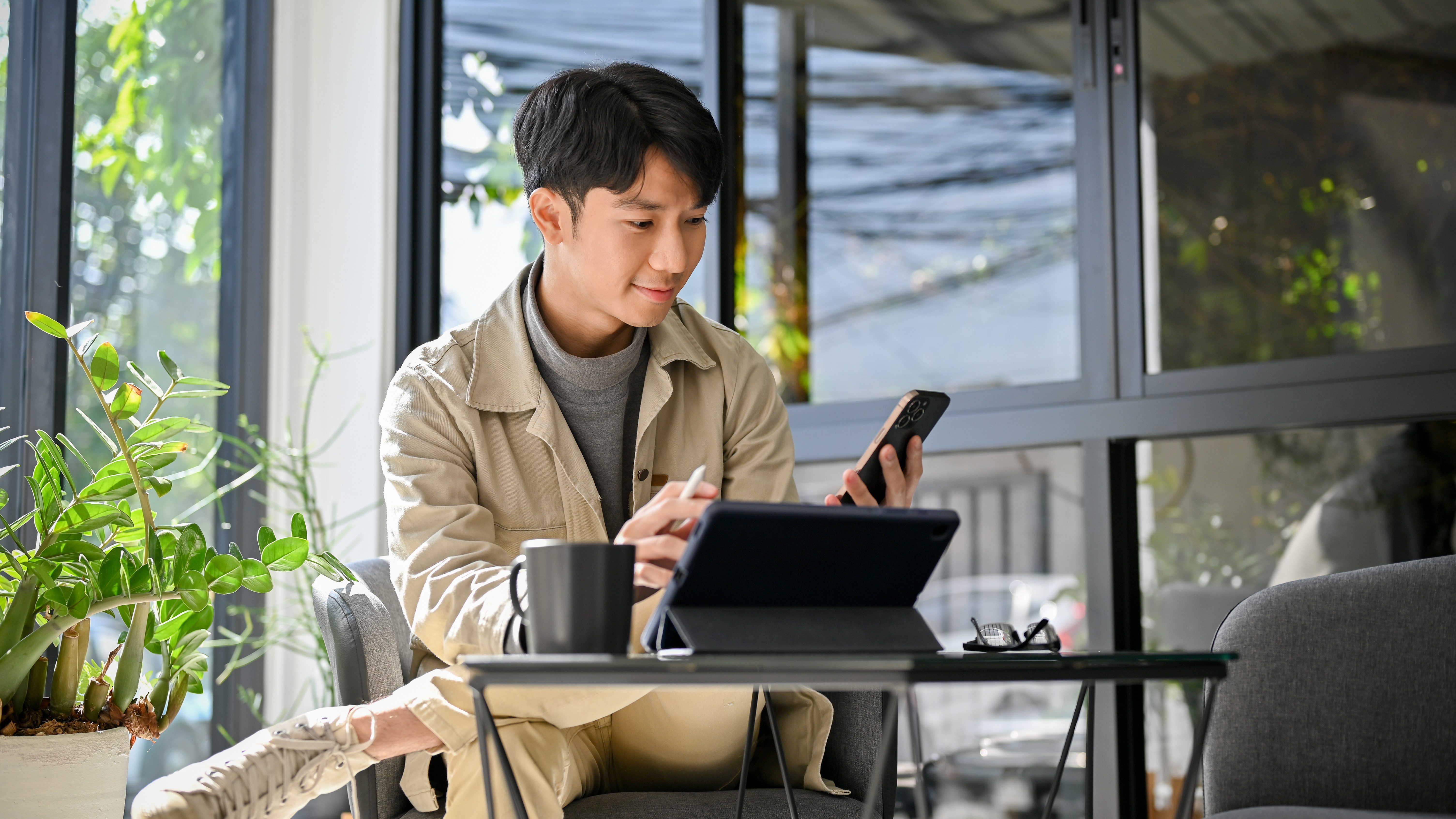 A young man checks his free online checking account on his mobile device.