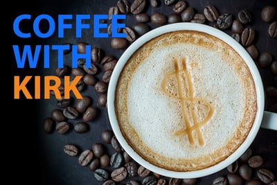 A coffee cup viewed from above with a dollar sign shape in the foam against a background of coffee beans and the background says 